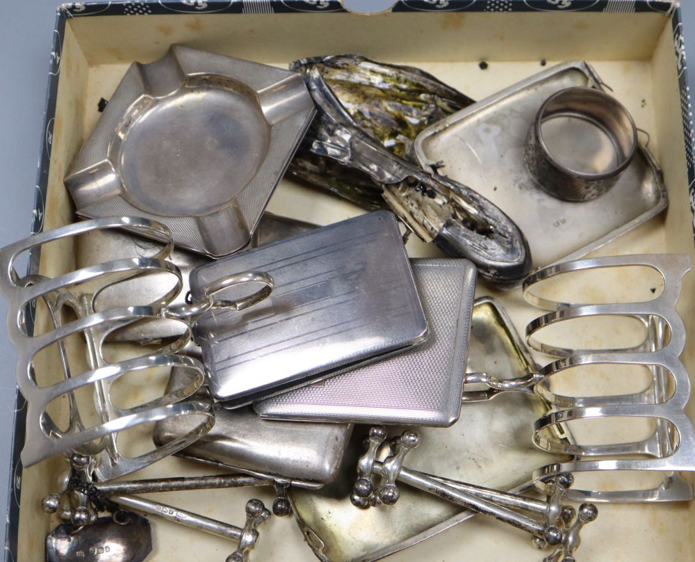Small silver and other items including a pair of toast racks, four knife rests, ashtrays, 19th century wine label etc.